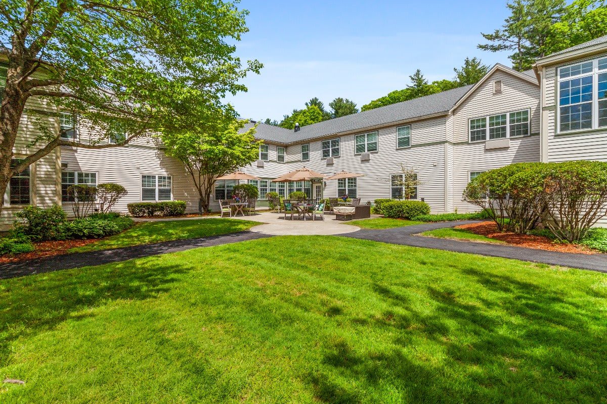 A beautiful house with a well-maintained lawn and garden on a sunny day.