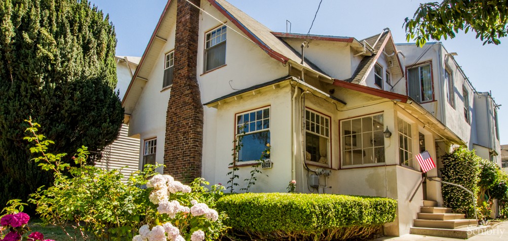 A charming house with a garden and blooming flowers in the foreground.