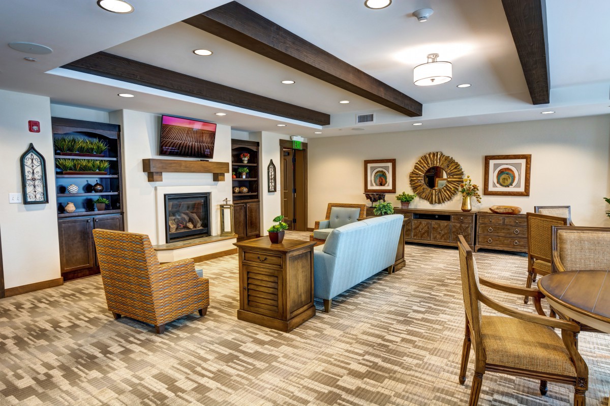 A modern living room with stylish furniture and a cozy fireplace.