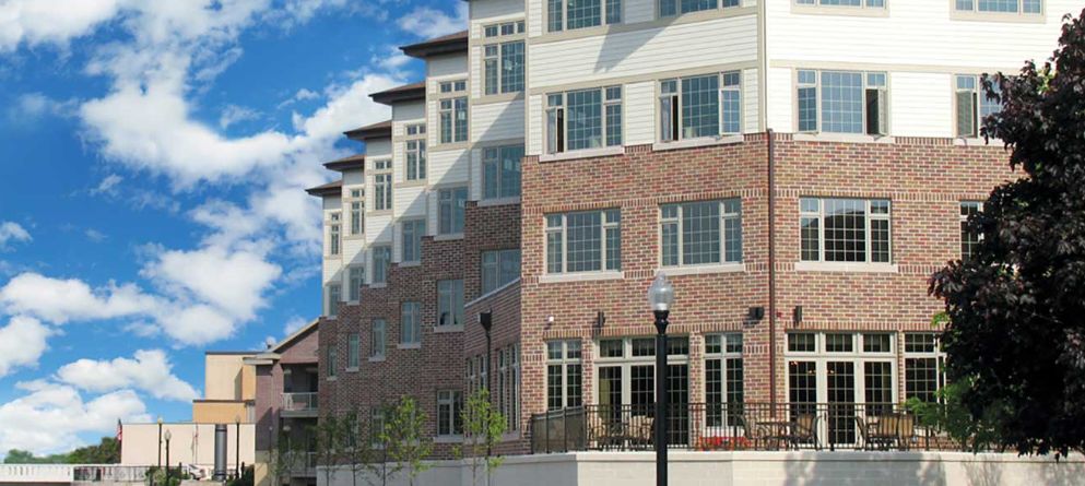 A modern residential building with brick exterior and large windows.