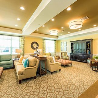 A cozy and elegantly decorated living room with comfortable seating and warm lighting.