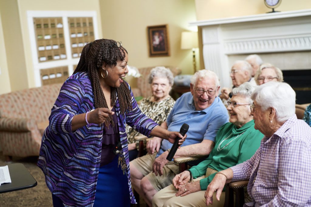 A lively group of seniors enjoying a social activity together indoors.