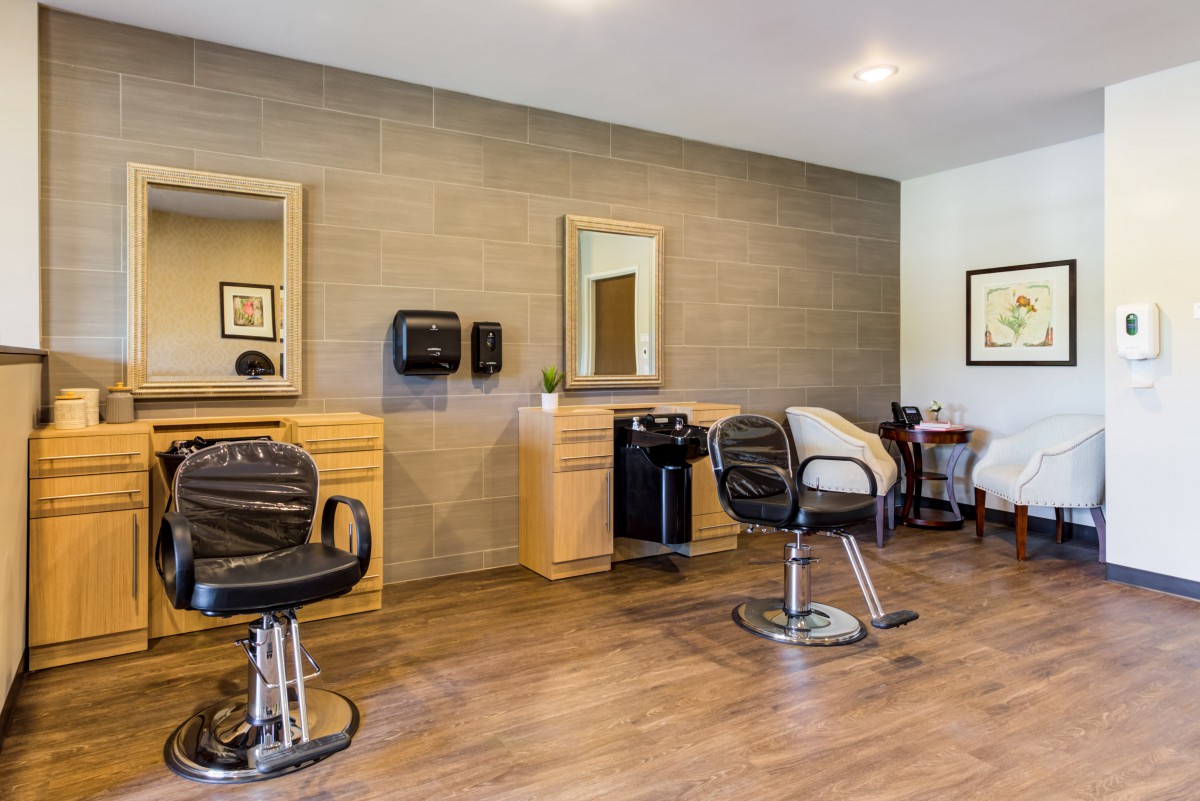 A modern salon interior with barber chairs and mirrors.