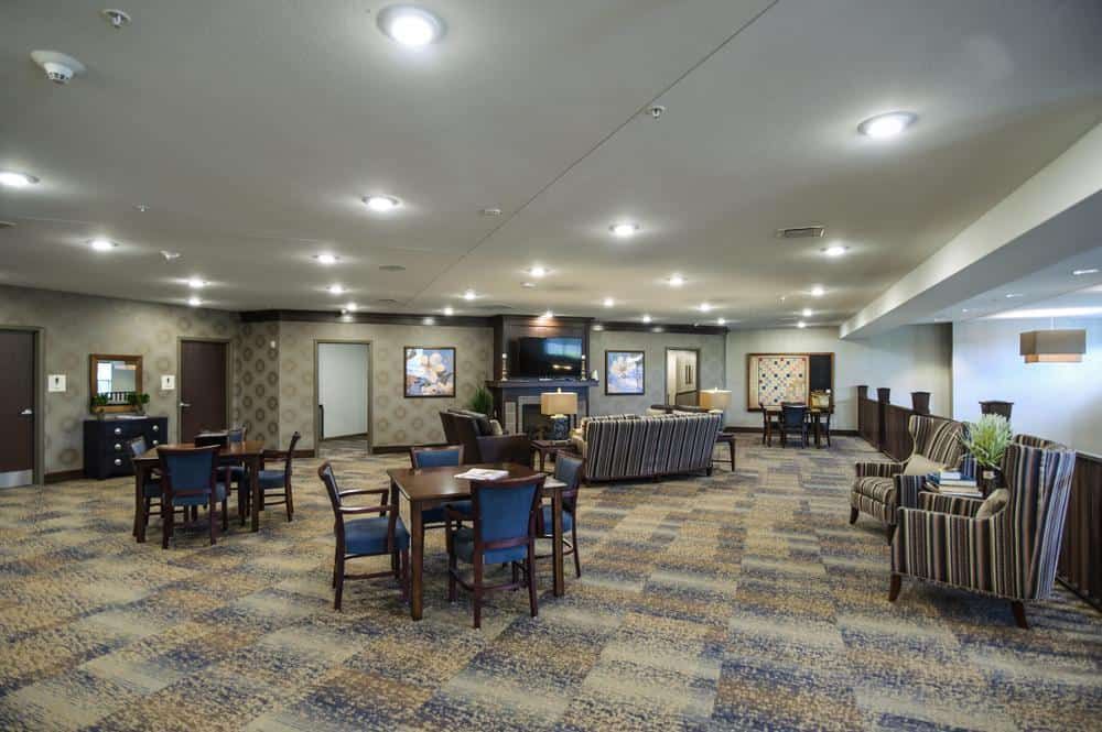 A spacious lobby with multiple seating areas and modern decor.