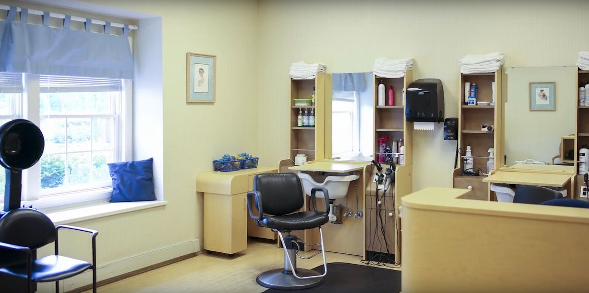 A well-organized hair salon with a barber chair and styling tools.