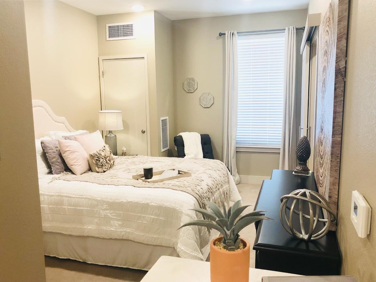 A cozy and modern bedroom with minimalist decor and natural lighting.