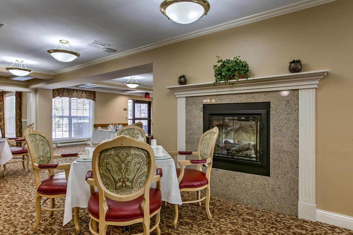 Elegant dining room with a cozy fireplace and classic furnishings.