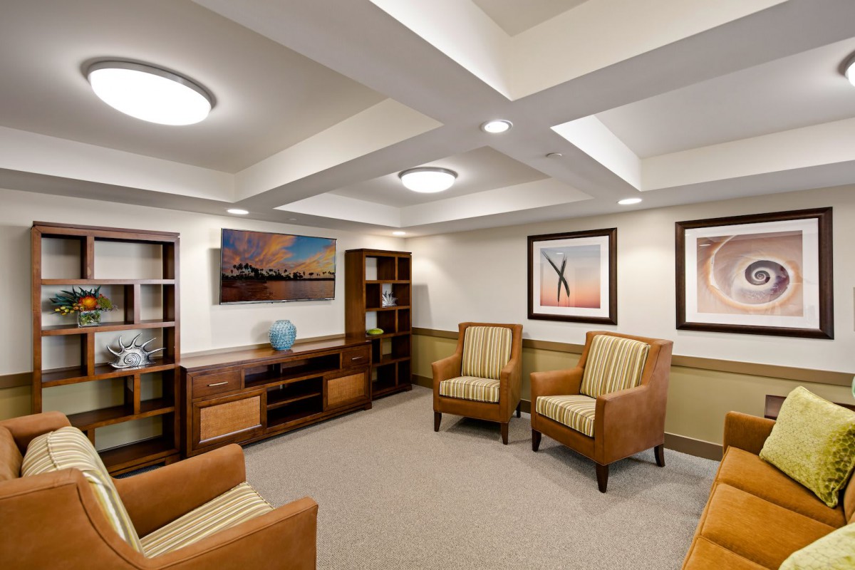 A modern waiting room with comfortable chairs and elegant artwork.
