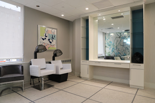 A modern and inviting waiting area featuring sleek furniture and contemporary artwork.