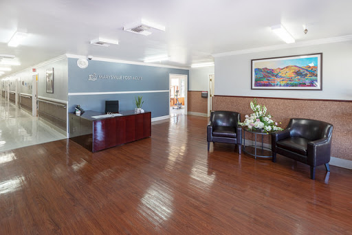 A spacious and well-lit office lobby with comfortable seating and a reception desk.