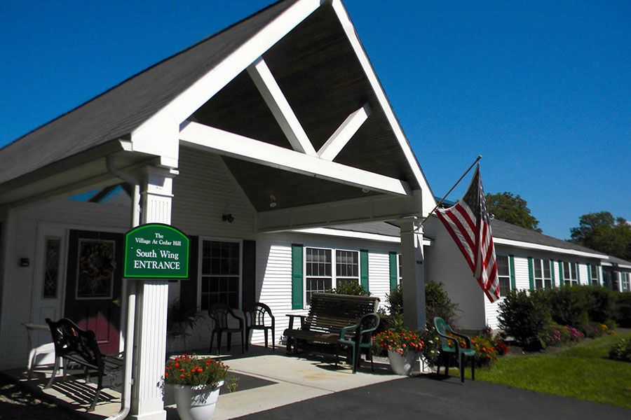 A welcoming entrance with a patriotic theme, featuring a porch and an American flag.