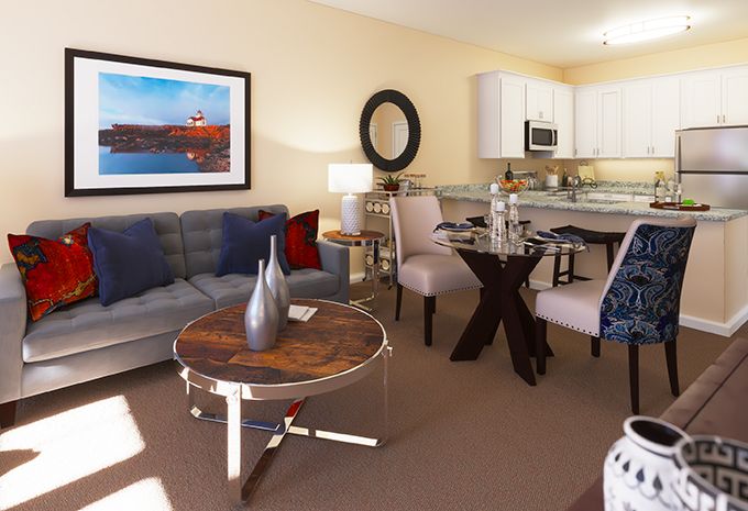 A modern living room and kitchen area with stylish furniture and decor.