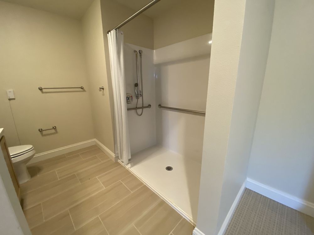 Spacious bathroom with a walk-in shower and modern fixtures.