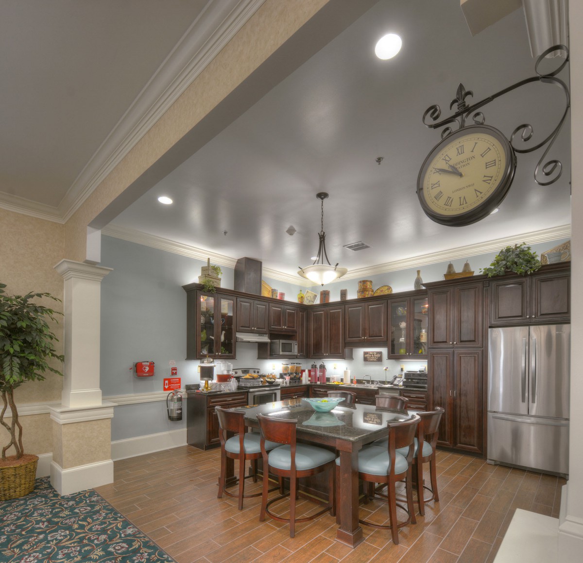 A modern kitchen interior with wood cabinets, an island counter, and stainless steel appliances.