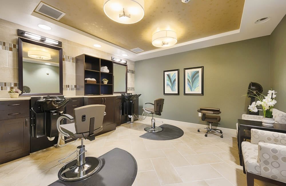 A modern hair salon interior with styling chairs and mirrors.