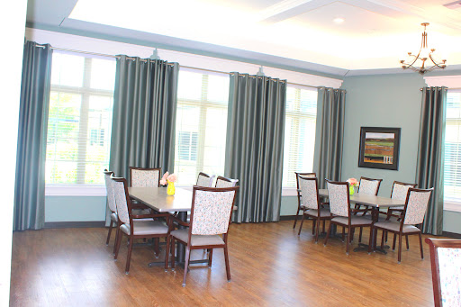 A spacious dining area with elegant furniture and natural light.