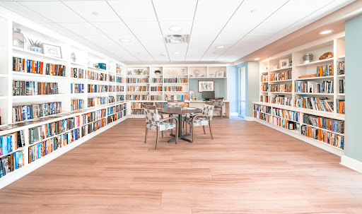 A bright and inviting library space featuring ample bookshelves and a cozy reading area.