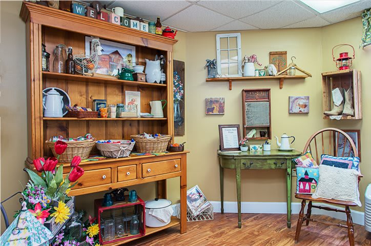 A cozy vintage shop interior with wooden shelves filled with antiques and collectibles.
