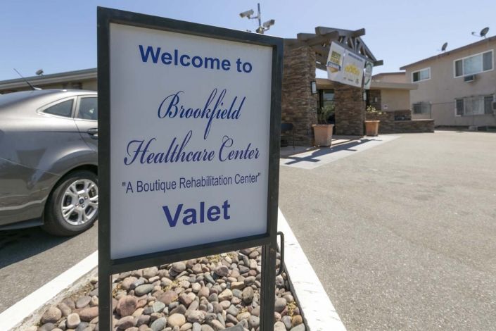 Entrance sign for Brookfield Healthcare Center with valet service.