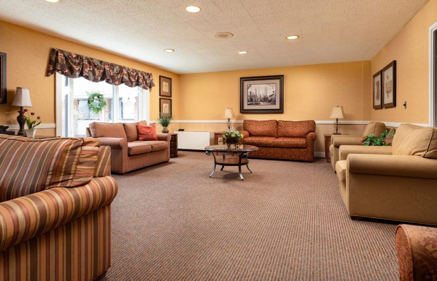 A cozy living room with comfortable couches, a coffee table, and warm lighting.