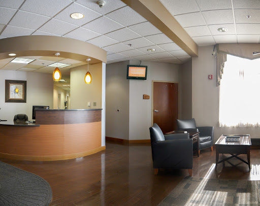 A modern reception area featuring comfortable seating and a flat-screen TV.