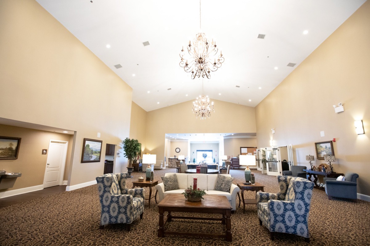 A spacious lobby area with elegant chandeliers and comfortable seating.