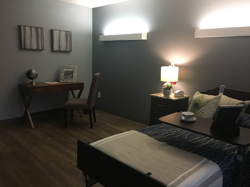 A modern bedroom with a cozy ambiance featuring a bed, desk, and stylish decor.