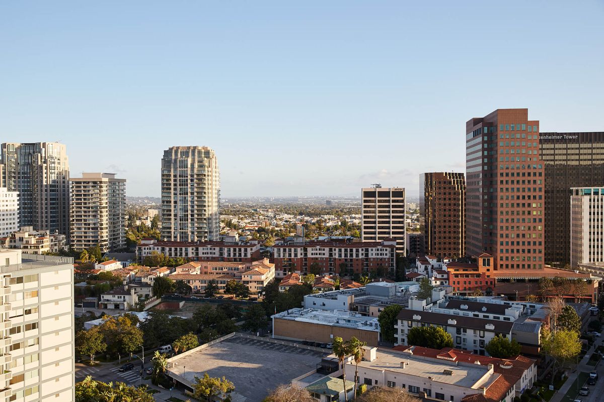 A panoramic view of a city skyline with tall buildings and clear skies.