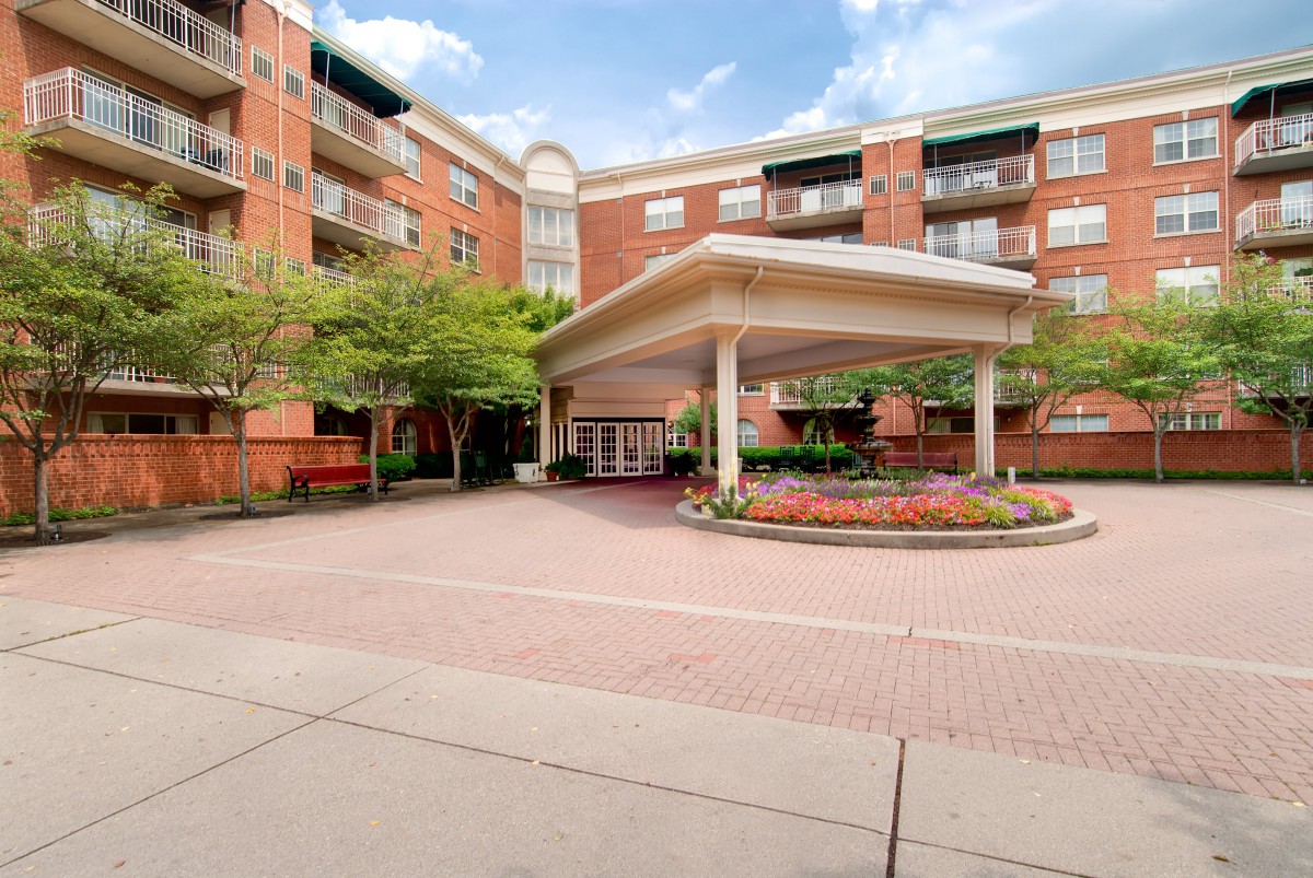 A residential apartment building with a landscaped entrance area.