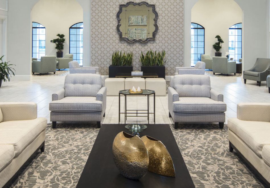 Sophisticated modern living room with plush seating and abstract decor.