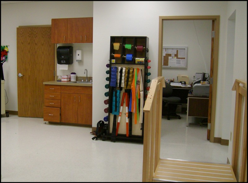 A rehabilitation facility with exercise equipment and an office area.