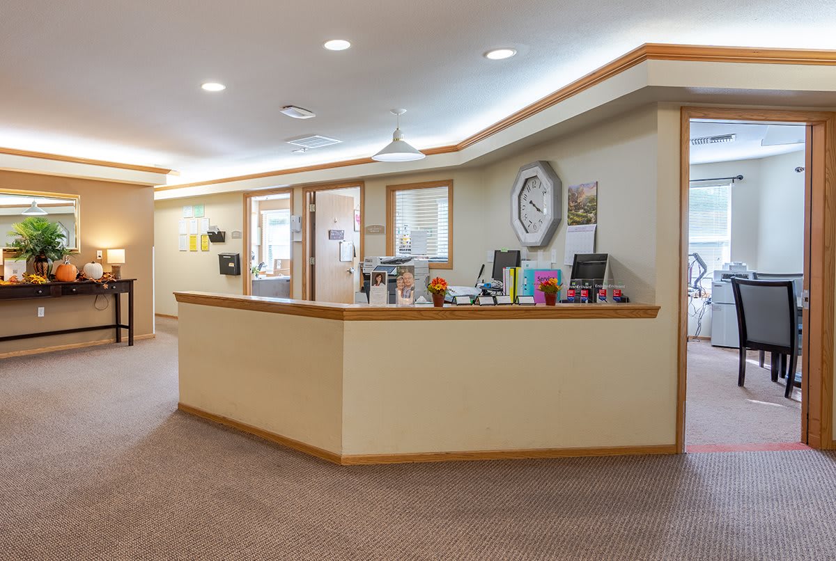 A spacious reception area with a central desk and modern decor.