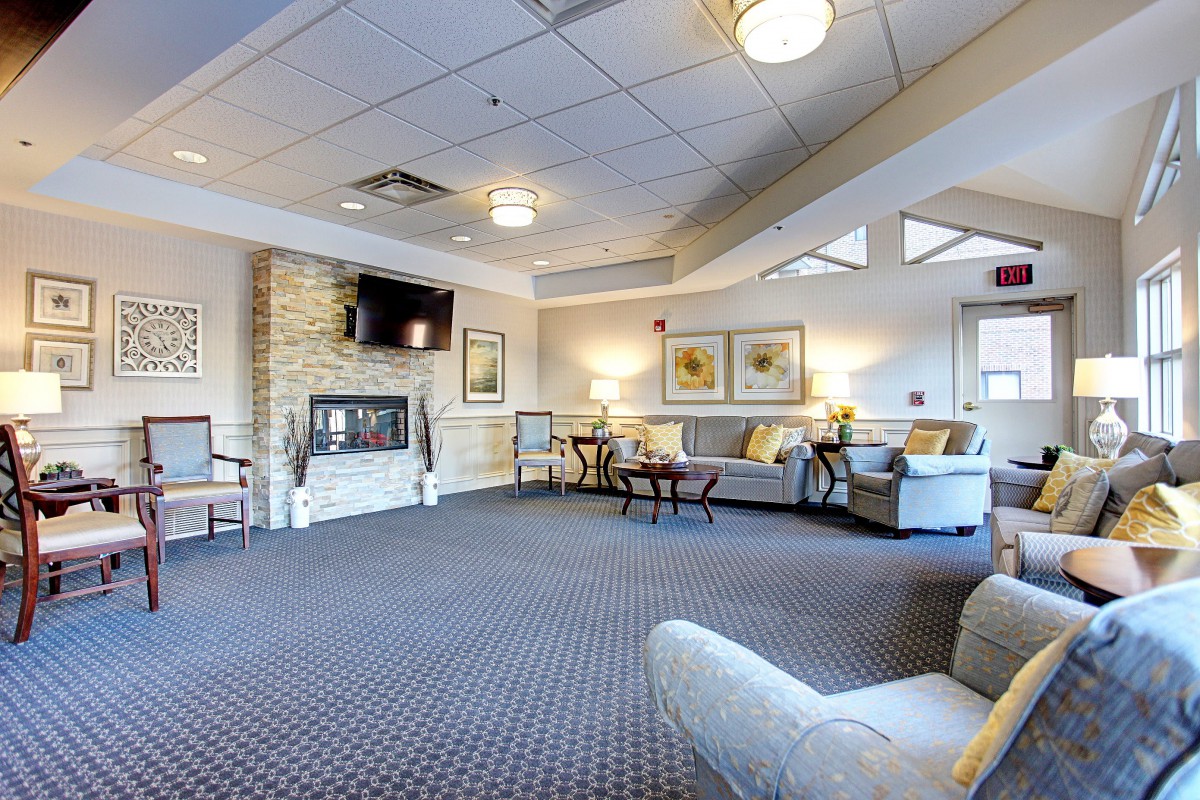 A spacious and modern living room with comfortable seating and a fireplace.