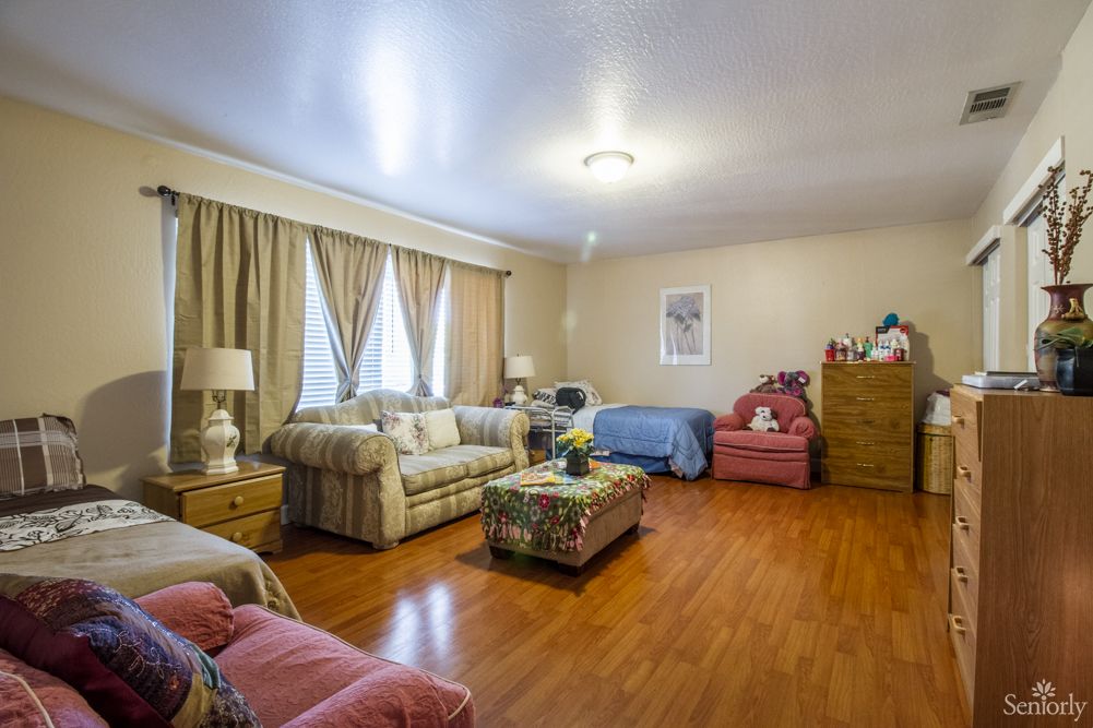 A cozy living room with comfortable seating and wooden flooring.