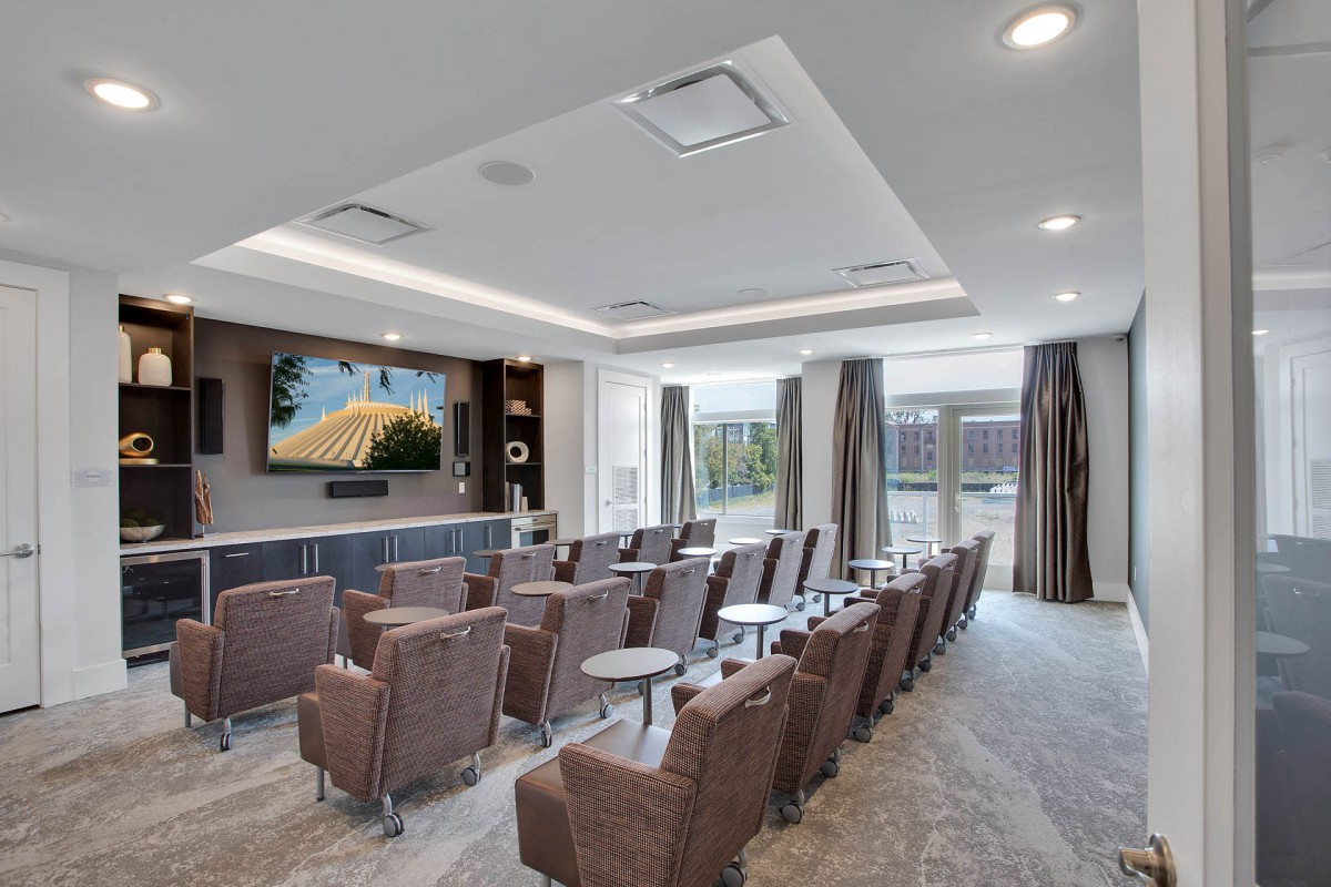 A modern home theater with comfortable seating and a large screen.