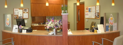 A view of a reception desk adorned with fresh flowers in a modern office setting.
