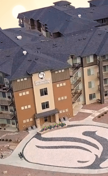 Aerial view of a modern apartment building with unique architectural design.