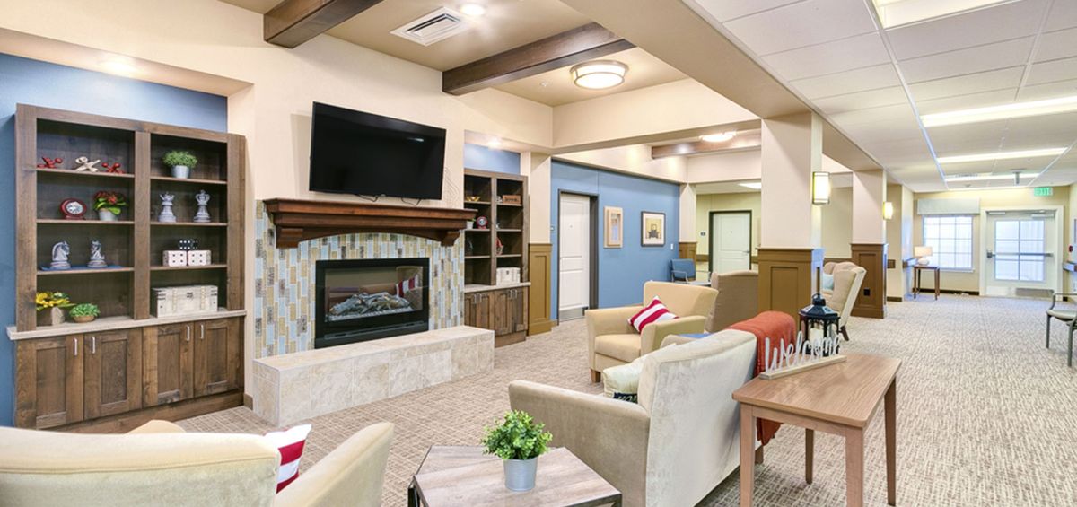 A modern living room with a fireplace, television, and comfortable seating area.