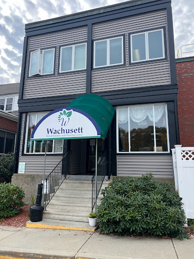 The entrance of a multi-story building with an awning, showcasing the name 'Vashtinett'.