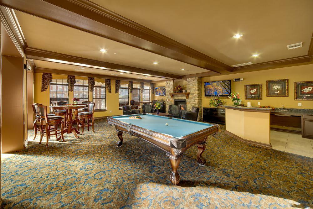 A cozy recreation room featuring a pool table and seating area.
