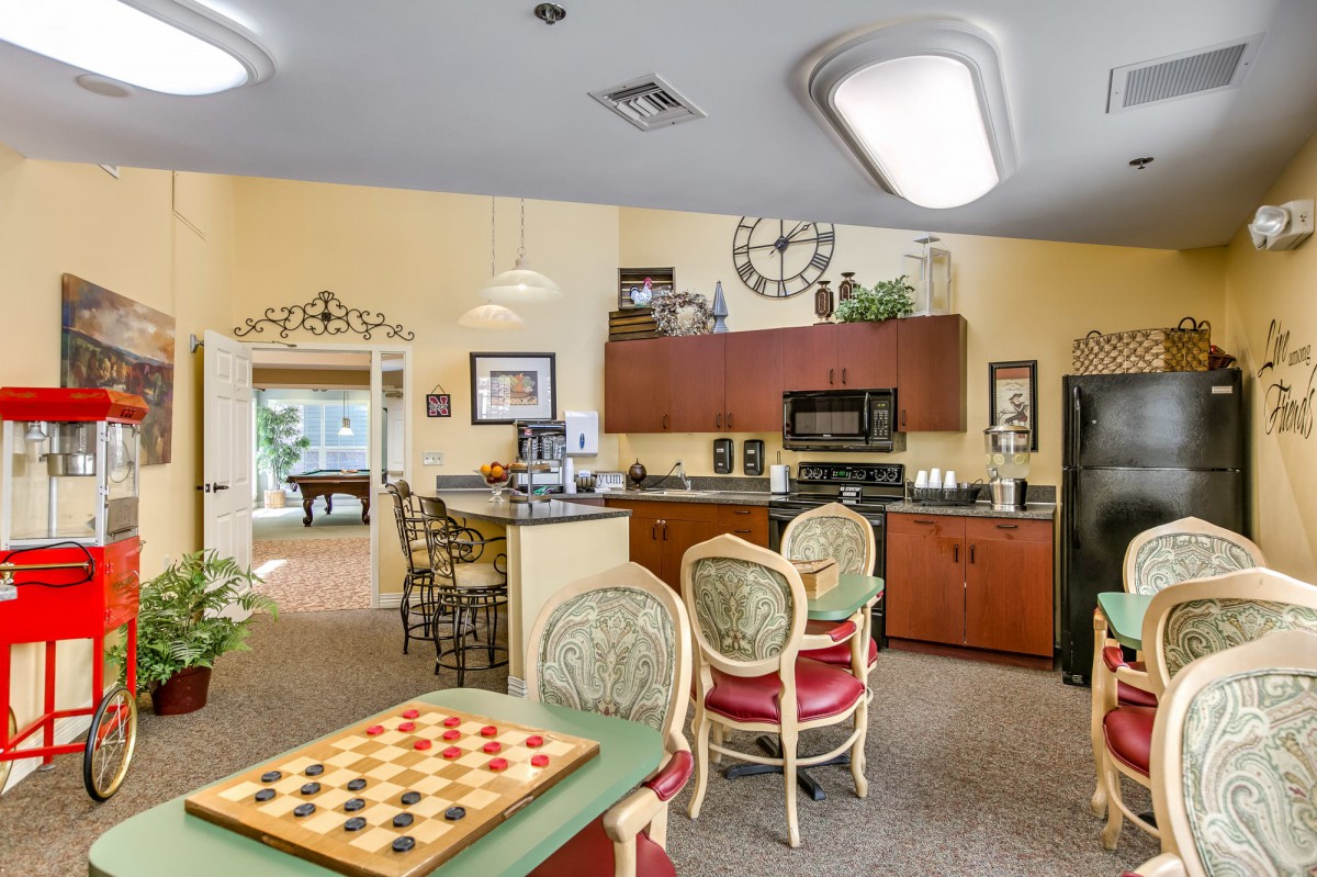 A cozy kitchen and dining area featuring a checkers board on the table and modern decor.