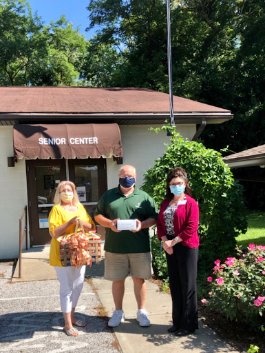 Community members come together to make a donation outside the local community center.