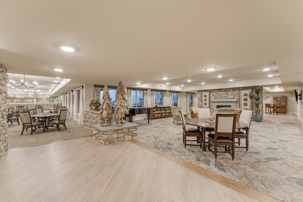 A spacious and elegant living area with a fireplace, featuring comfortable seating and dining spaces.