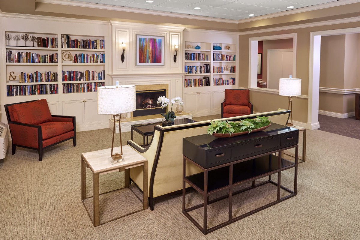 A cozy living room with modern furniture and built-in bookshelves.
