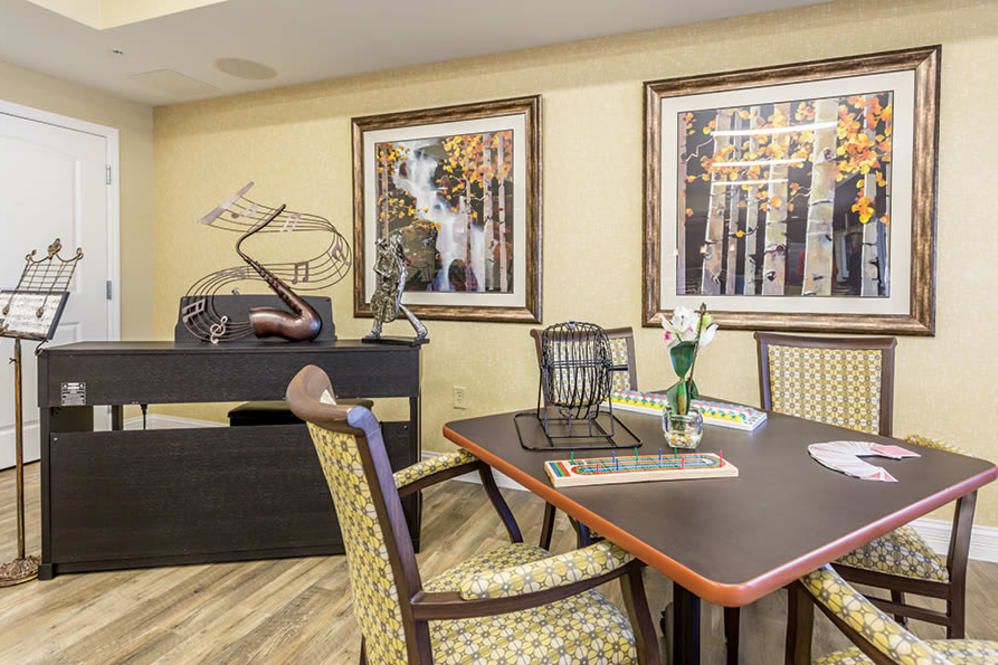 A formal dining area with a table, chairs, and decorative artwork on the walls.