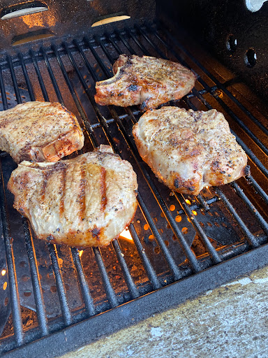 Delicious steaks grilling to perfection.