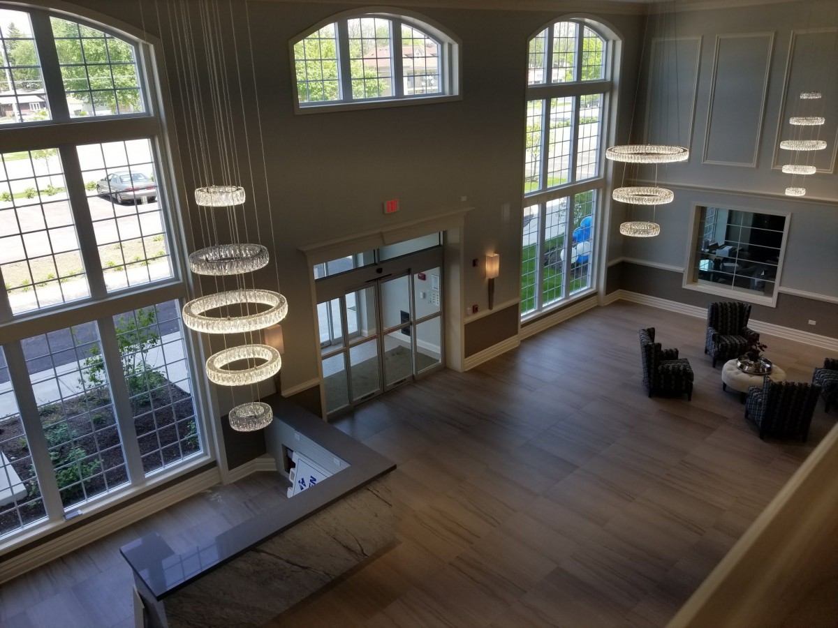 A spacious and modern lobby with large windows and contemporary lighting.