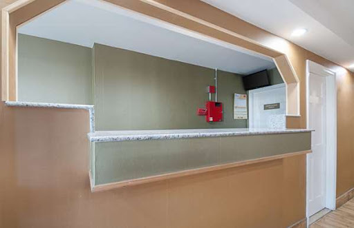 An interior view of a kitchen area featuring a counter with a fire extinguisher mounted on the wall.