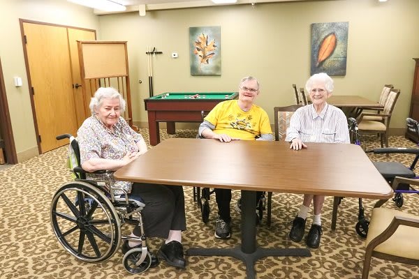 A group of seniors sitting together at a table indoors.