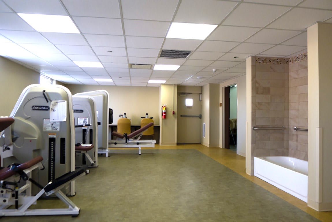 A modern gym interior with various exercise equipment.